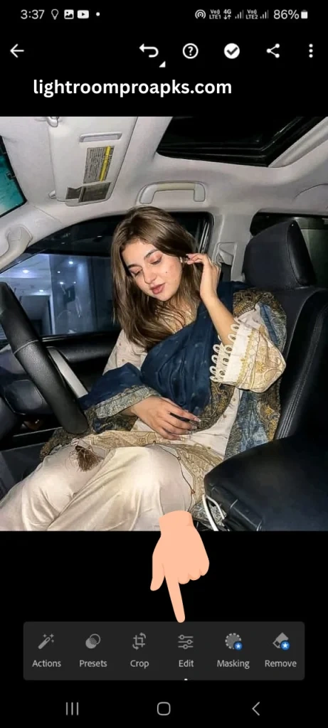 Lightroom mobile interface screenshot showing editing options with a hand pointer highlighting the edit button for photo adjustments.