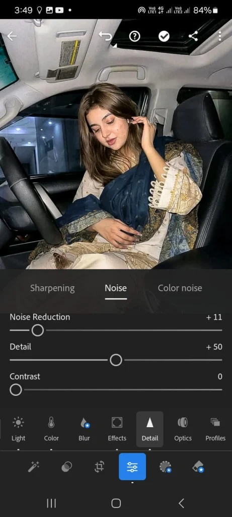 Lightroom mobile screenshot showing noise reduction panel with sliders for noise reduction, detail, and contrast applied to a portrait photo.