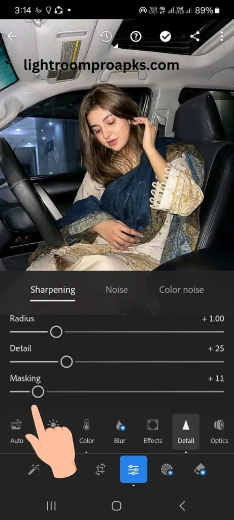 Lightroom mobile screenshot showing sharpening settings with masking slider highlighted by a hand pointer for refined photo sharpening.